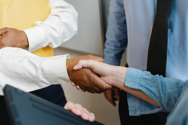 diverse partnership shaking hands