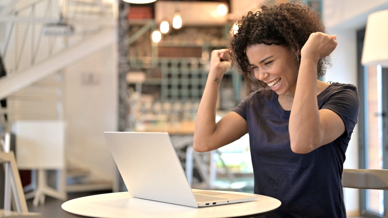 celebrating success on laptop